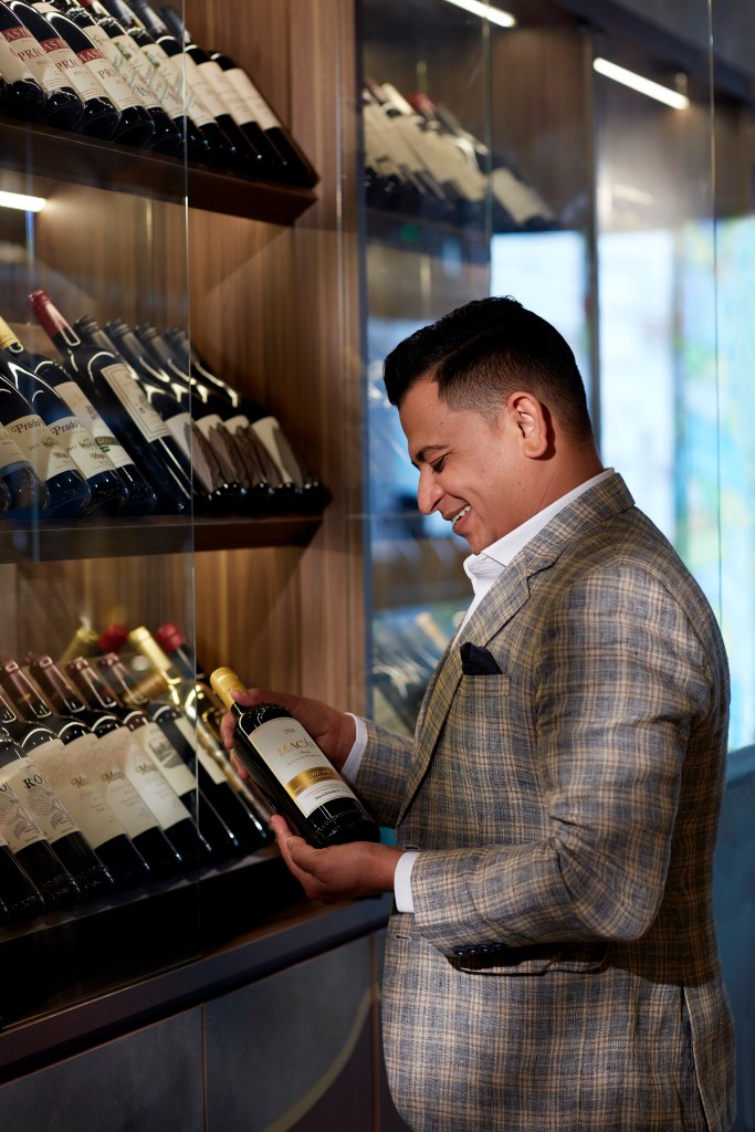 A bottle of wine in the hands of Azad